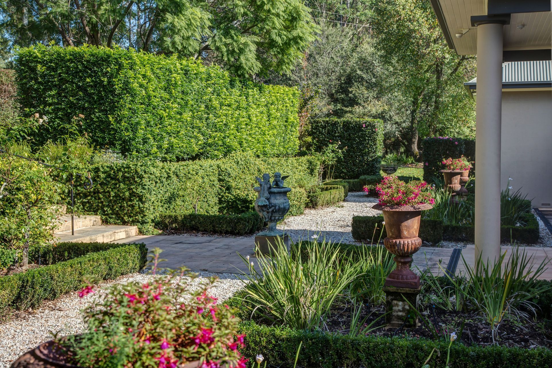 Garden Path Bordered By Hedges And Pink Flowers, With A Potted Plant And A House Porch — Shona Design In Mittagong, NSW