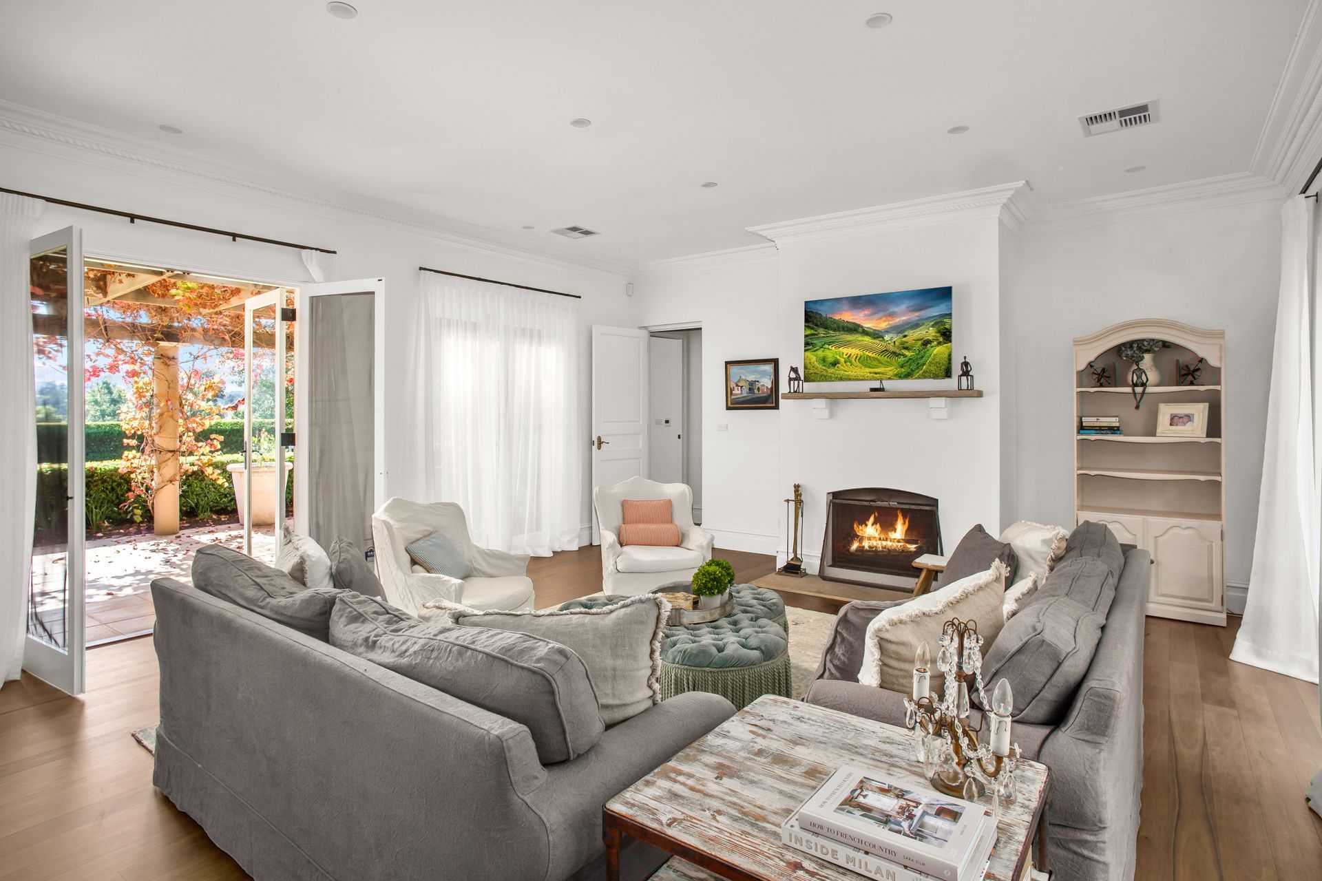 Bright Living Room With Gray Sofas, White Fireplace, And Open Patio Doors To A Sunny Garden — Shona Design In Mittagong, NSW