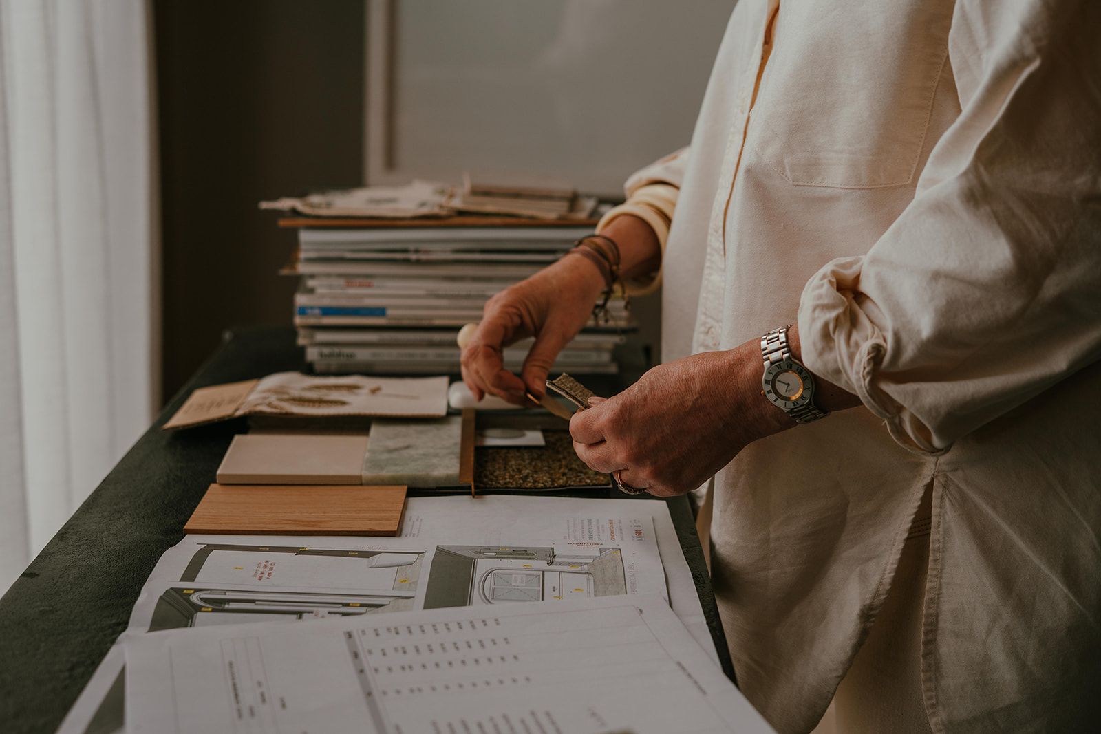 Person Sorting Papers at a Desk With Documents — Shona O'Brien Interior Design in Bowral, NSW