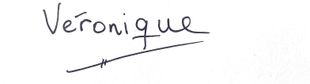 Handwritten name “Véronique” in black ink on white paper, underlined with a slanted line.