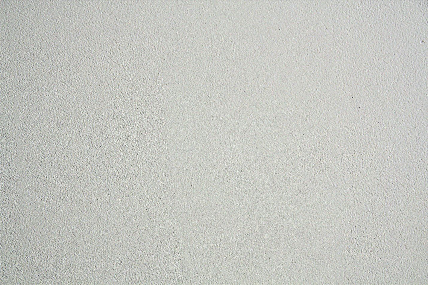 Light gray speckled textured surface filling the frame
