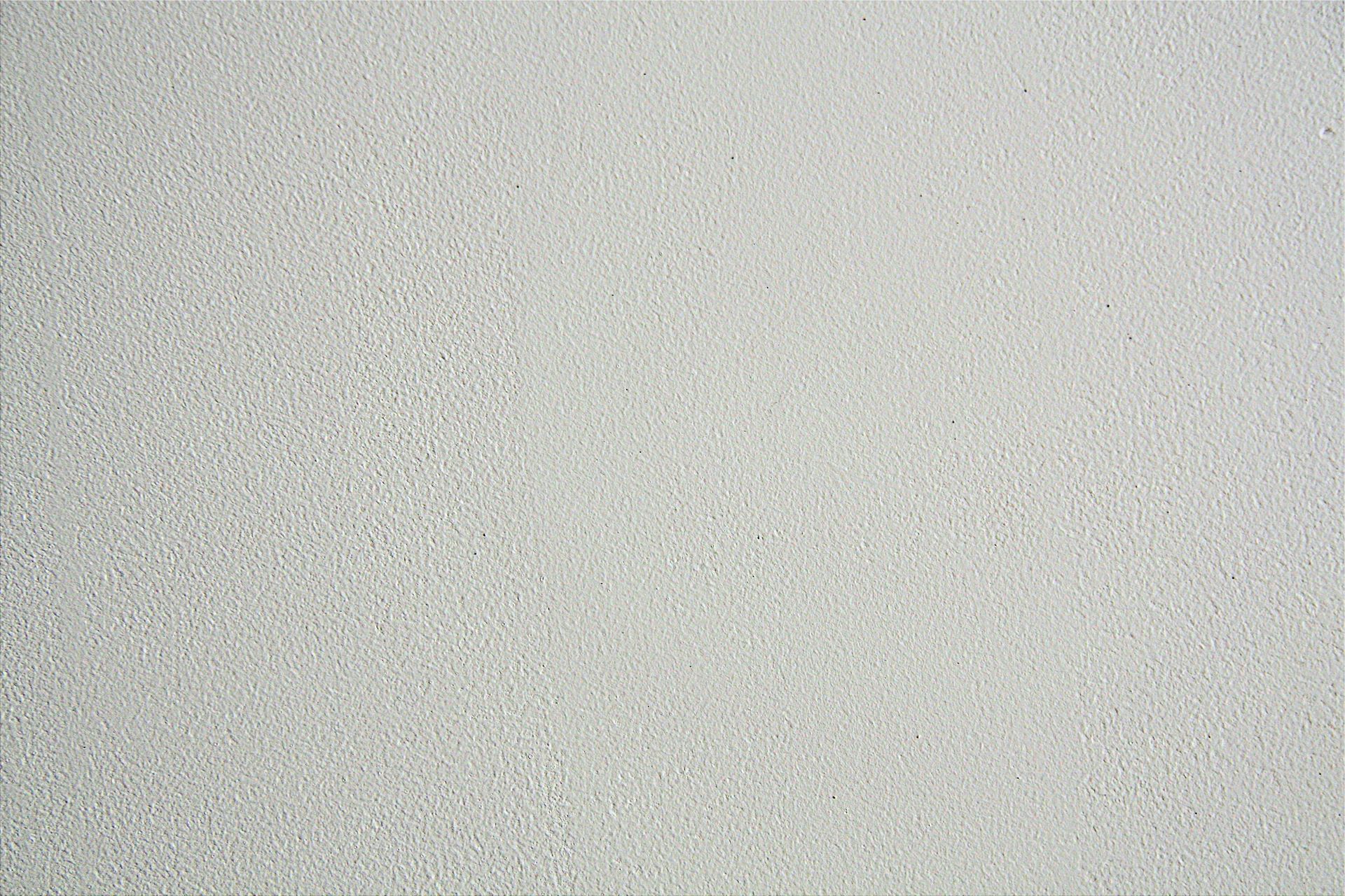 Light gray speckled textured surface filling the frame