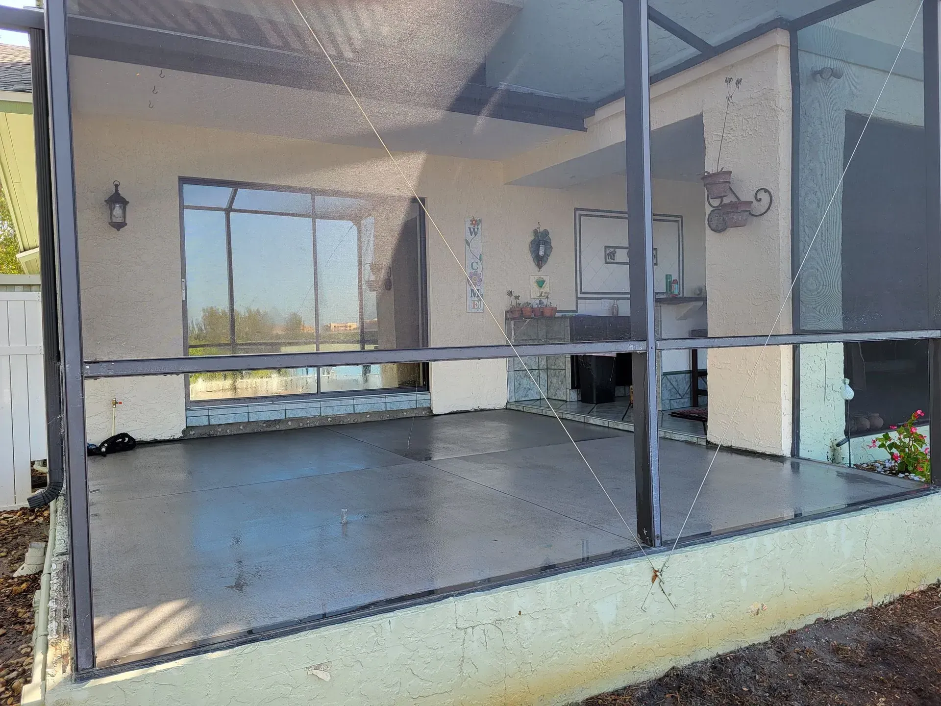 Screened porch with large windows, blue floor, and a view of the outdoors.