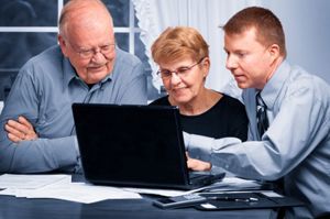 People looking at a laptop computer determining bankruptcy exemptions