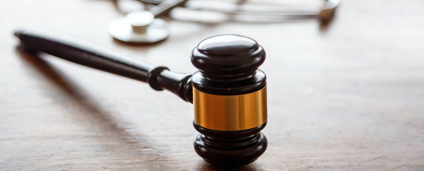 A judge 's gavel on a wooden table representing personal injury law in Lewisville, Texas.