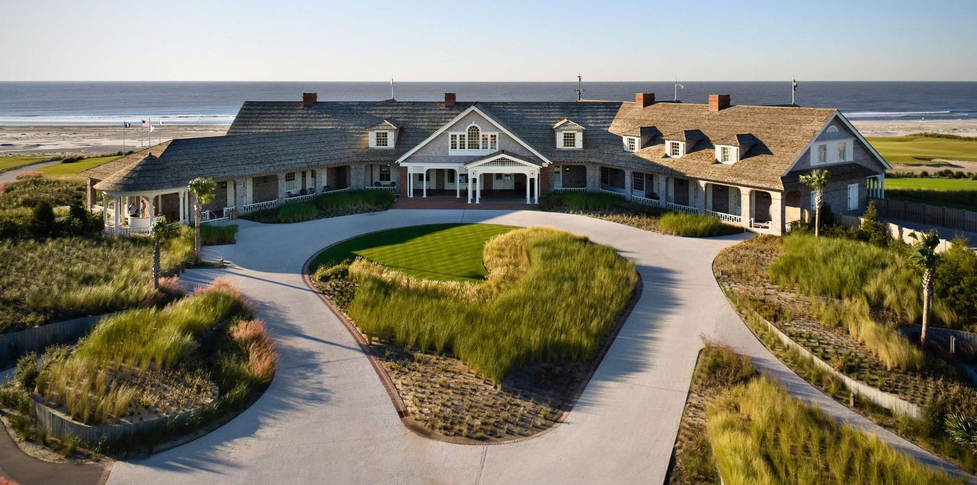 An aerial view of a large house with a driveway leading to it