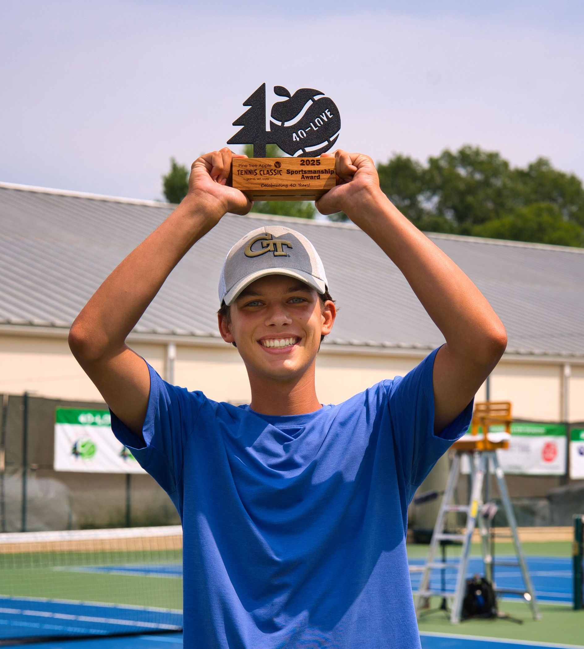 Paul Kolenich holds sportsmanship trophy