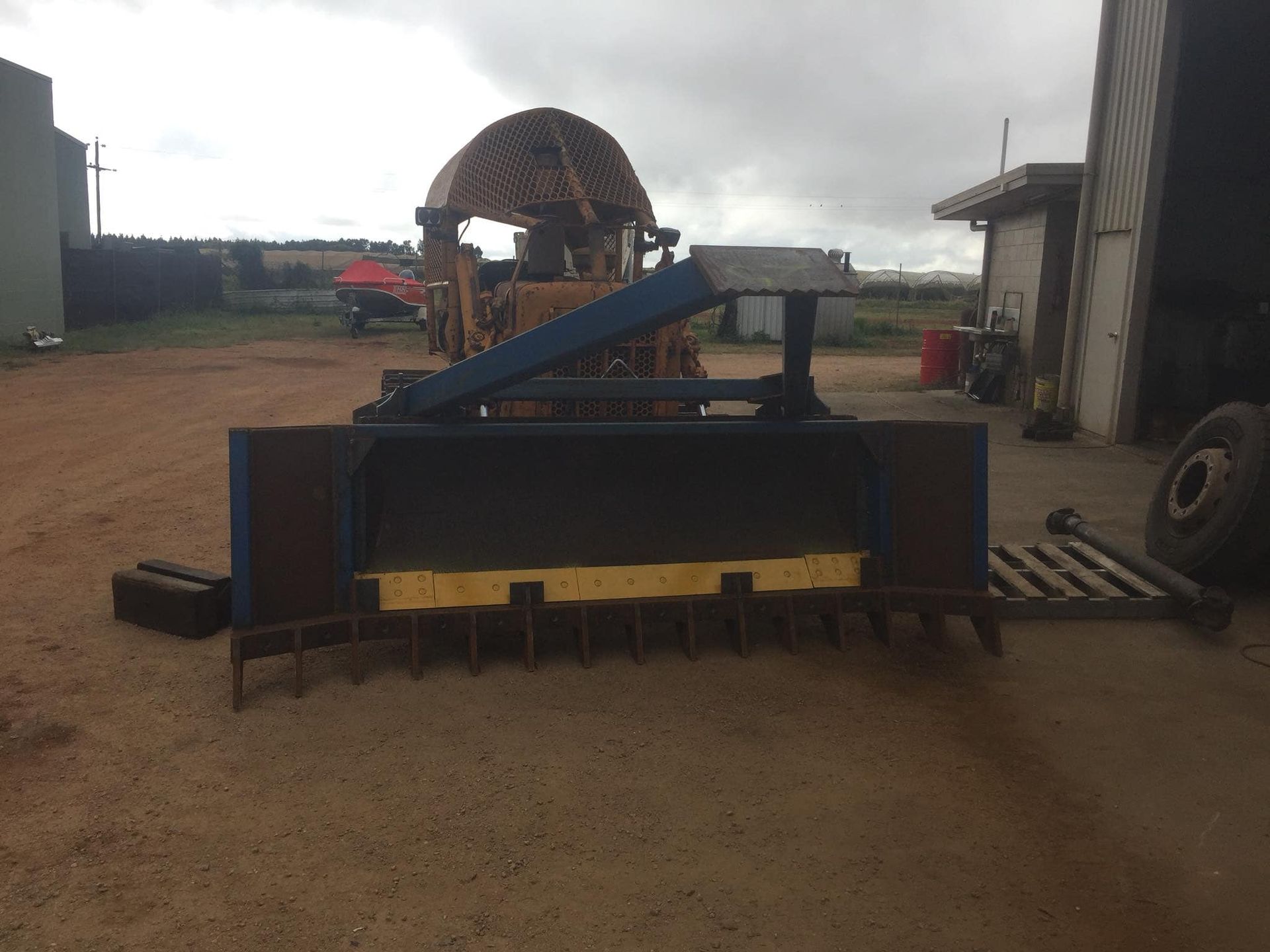 A Blue and Black Farm Implement With Yellow Tines — Boycey's Custom Engineering in Atherton, QLD