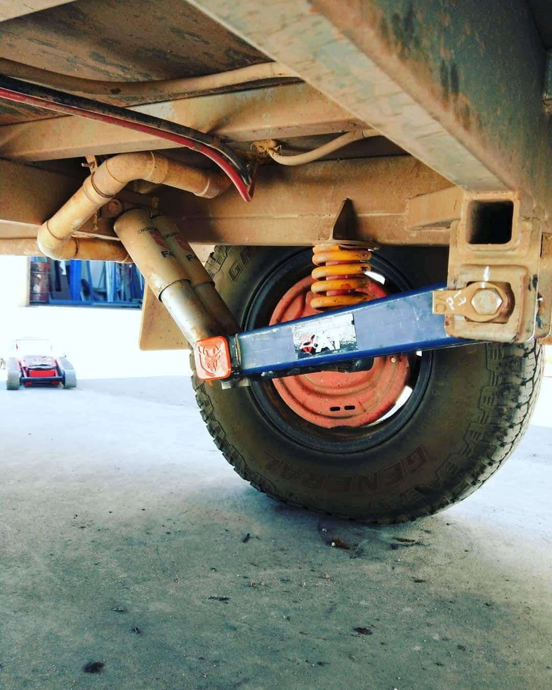 Undercarriage of a Trailer With a Blue Suspension Arm — Boycey's Custom Engineering in Atherton, QLD
