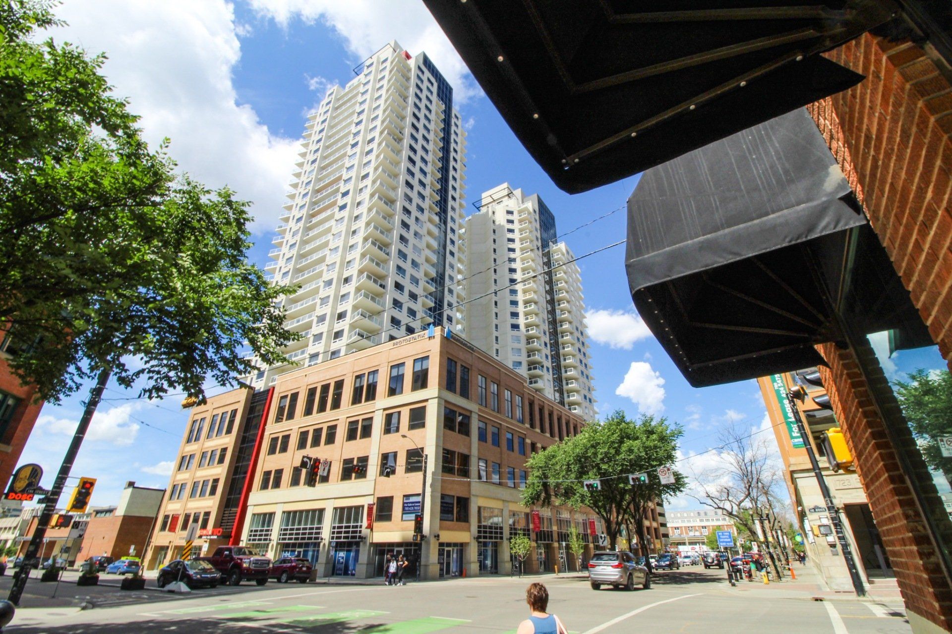 Twin white towers with white weight a beige brick podium in the daytime