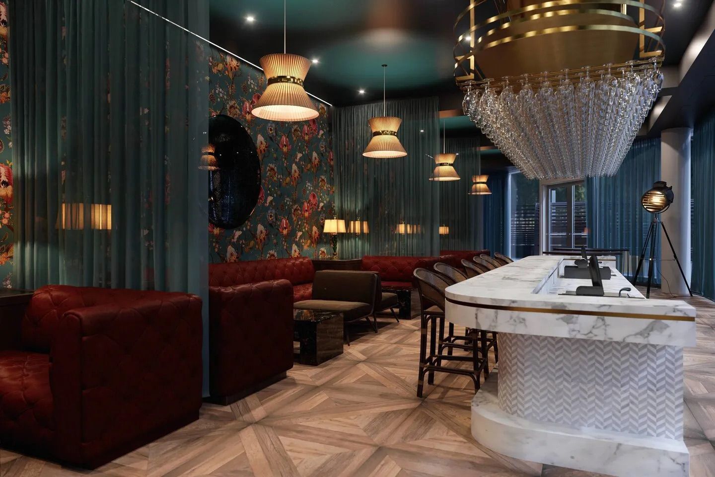 A fancy bar interior with red leather sofas, floral wallpaper, and a crystal chandelier.