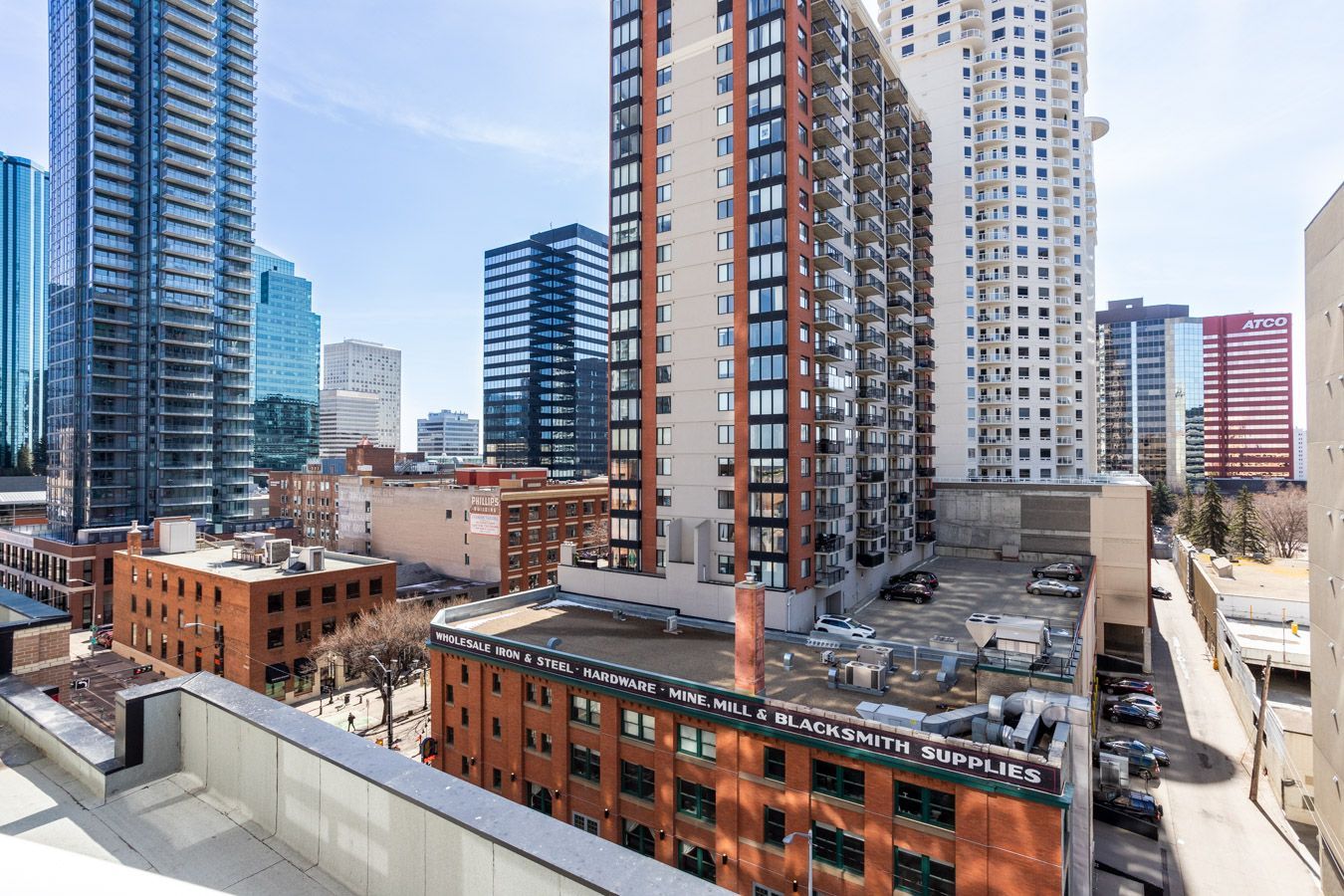 City skyline view: tall buildings, brick structures, sunny day.