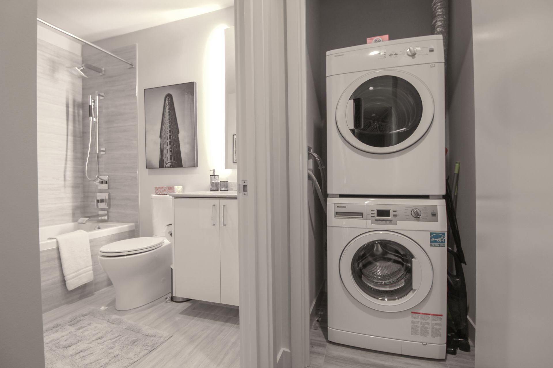Bathroom with a stacked washer and dryer visible from the doorway.