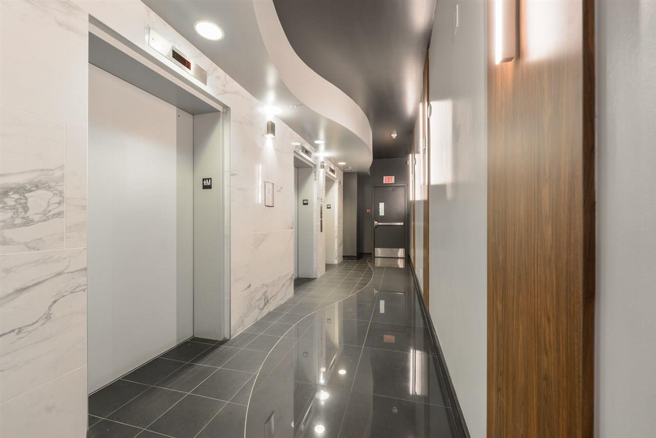 What marble lobby 3 elevator doors made of stainless steel
