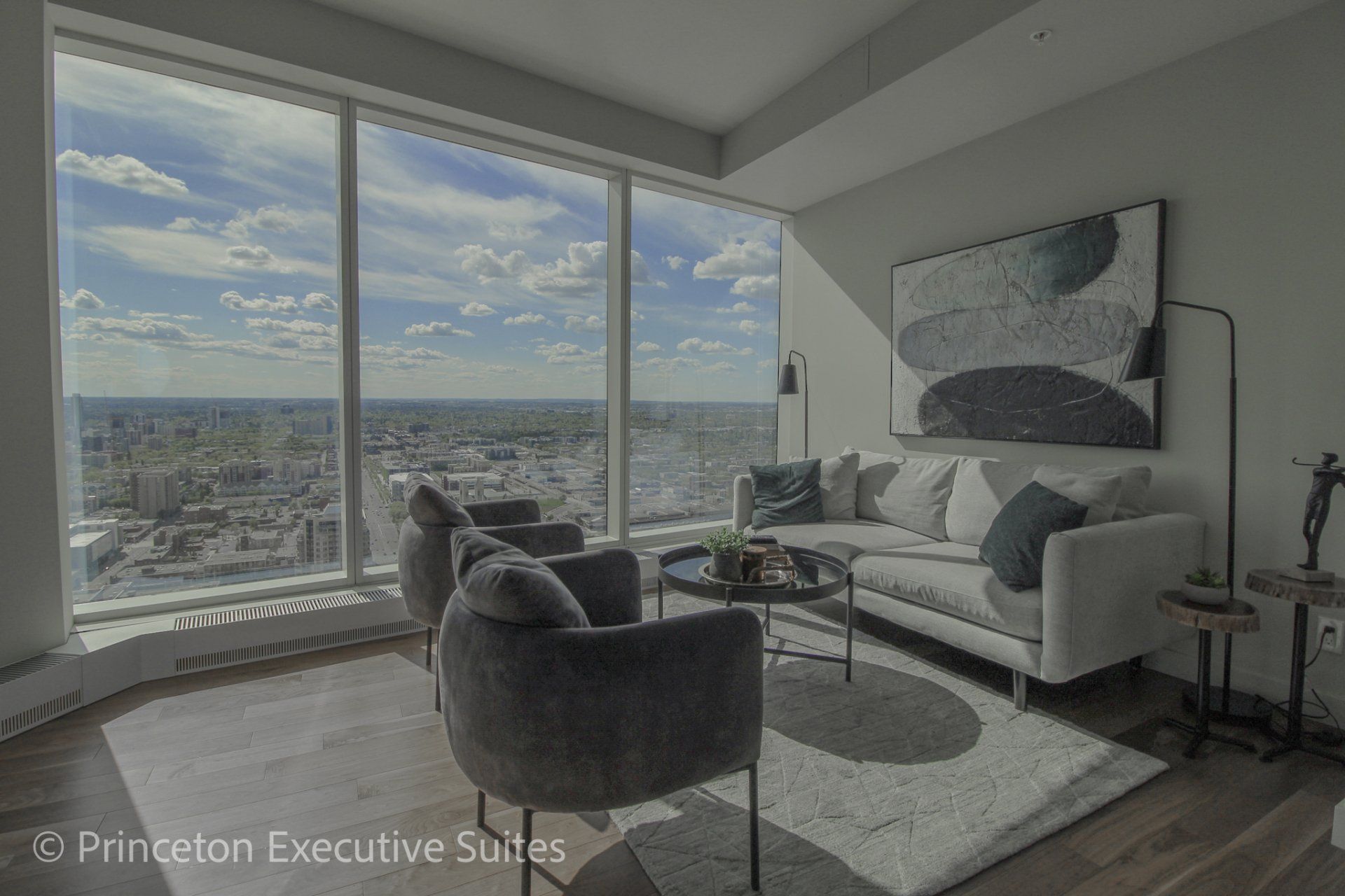 In this stunning furnished apartment in the legends tower downtown edmonton.  Grey furnishings , ceiling to floor windows