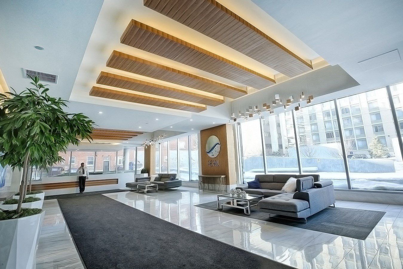 Majestic white marble grand lobby wiht vaulted wood and marble ceiling concierge desk in the back ground