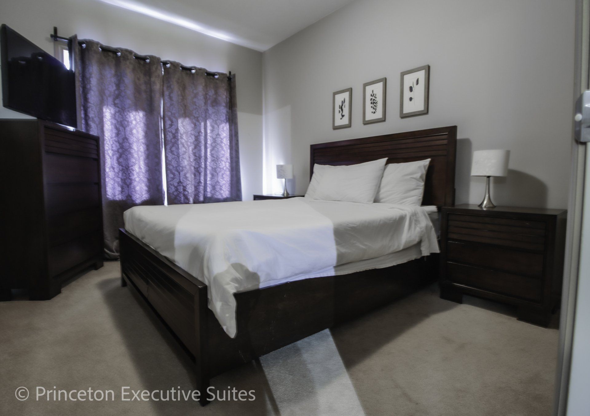 Edmonton furnished condo bedroom white linens dark brown queen sized bed and night stands