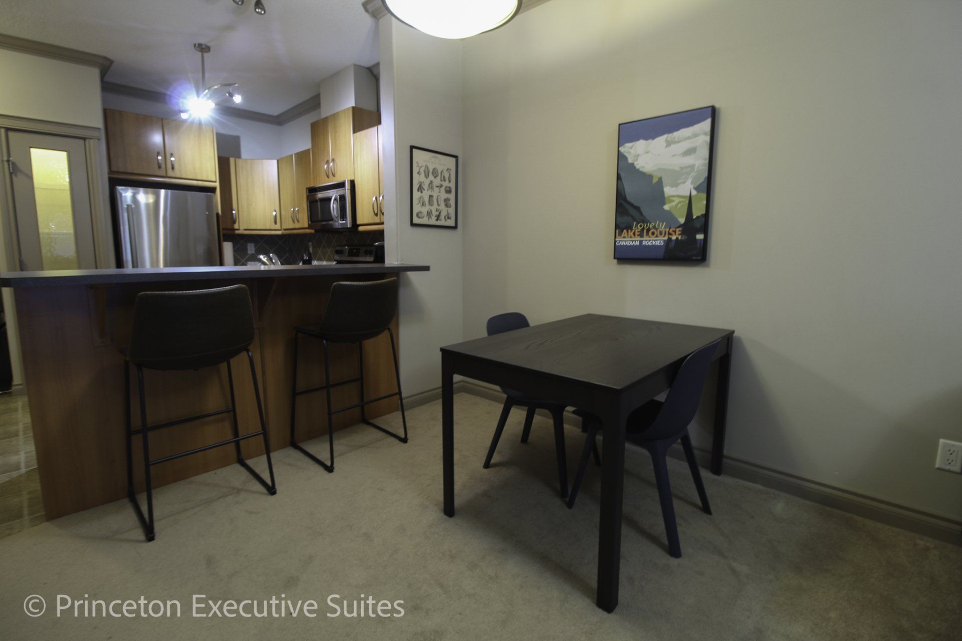 Dining area of Edmonton furnished condo eating bar and 3 barstools