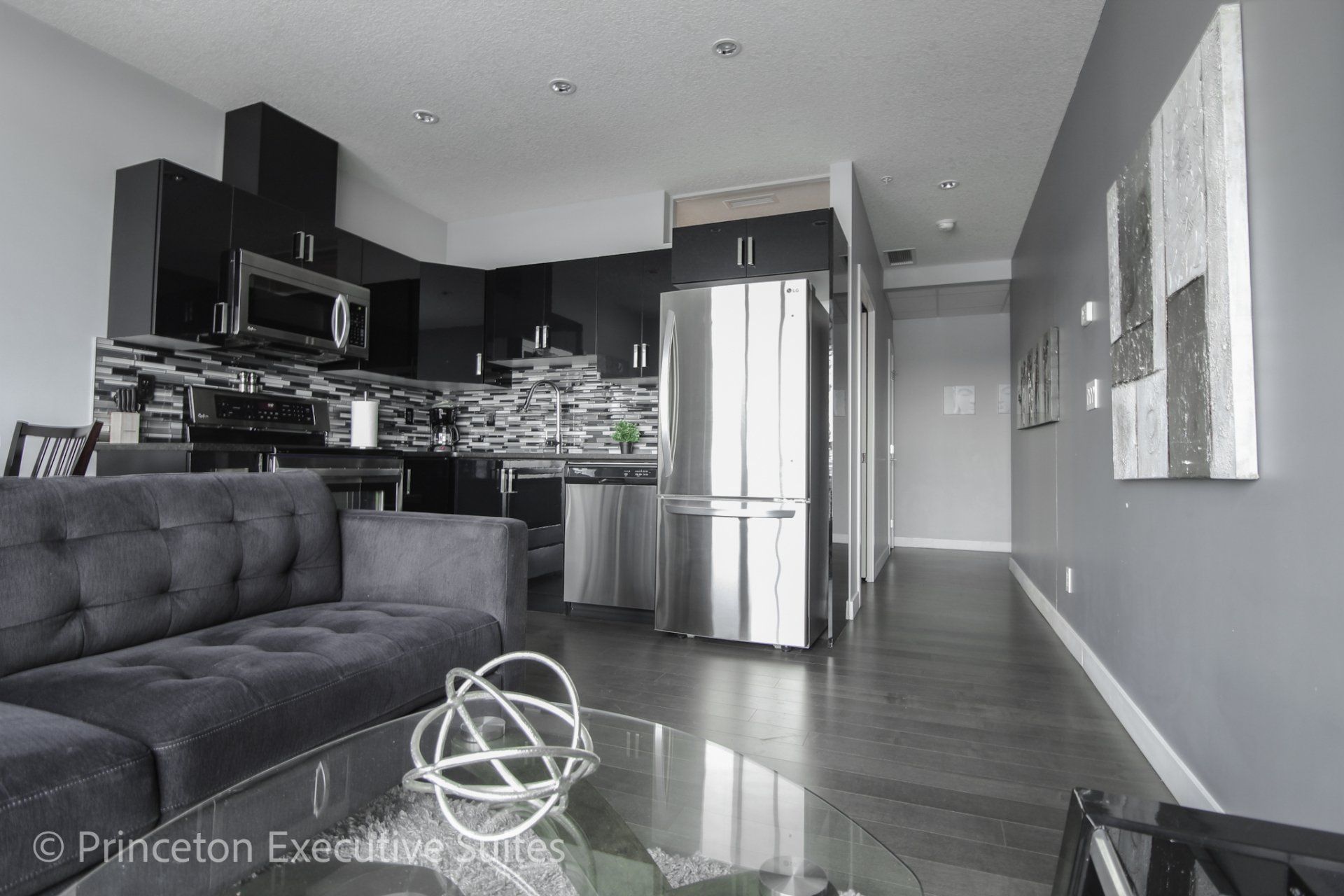 Kitchen with stainless steel appliance and espresso coloured cabinetry