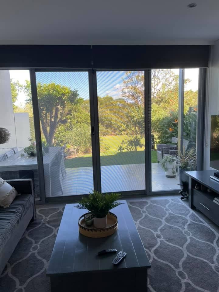 A Living Room With A Couch, Coffee Table, Doors — Central Coast Flyscreen Service In Warnervale, NSW