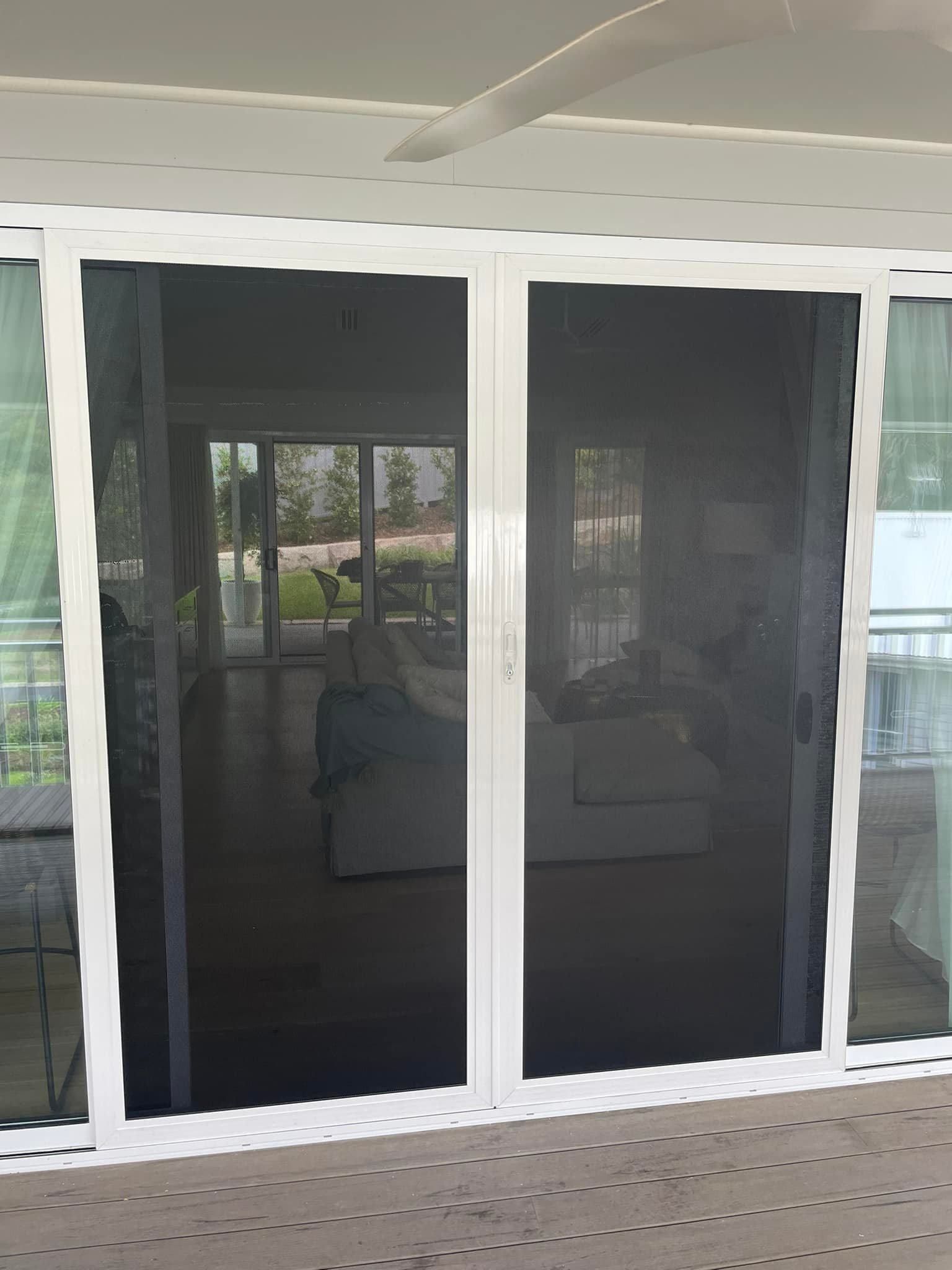 A Sliding Glass Door With A Screen On It Is Open To A Living Room — Central Coast Flyscreen Service In West Gosford, NSW