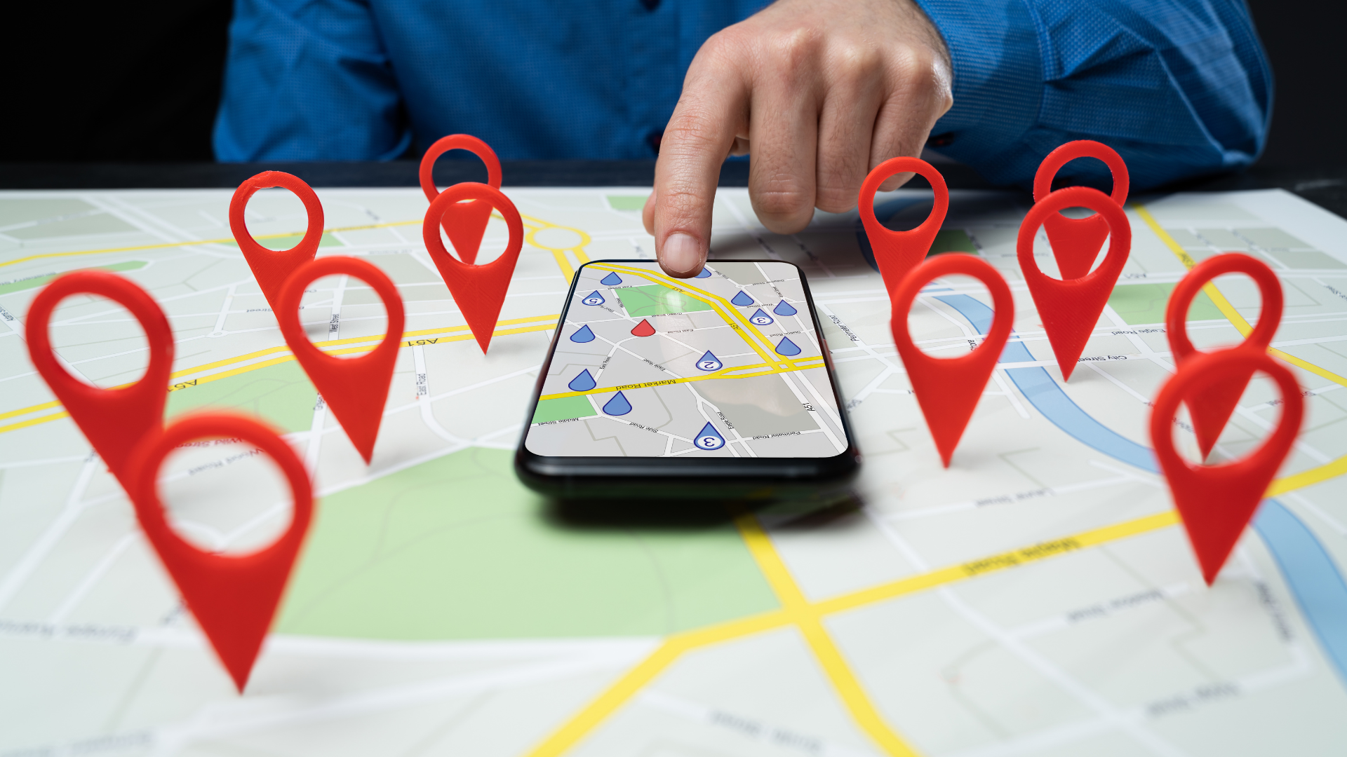 A person is using a smart phone to find a location on a map.