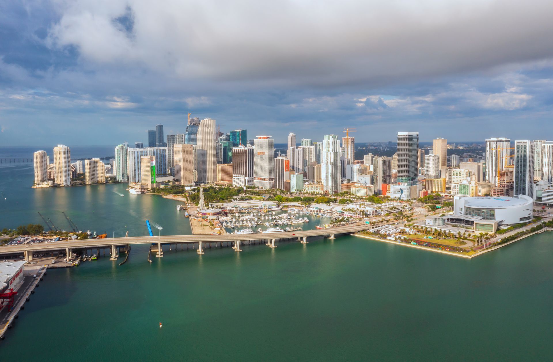 An aerial view of a city skyline surrounded by water on a cloudy day.