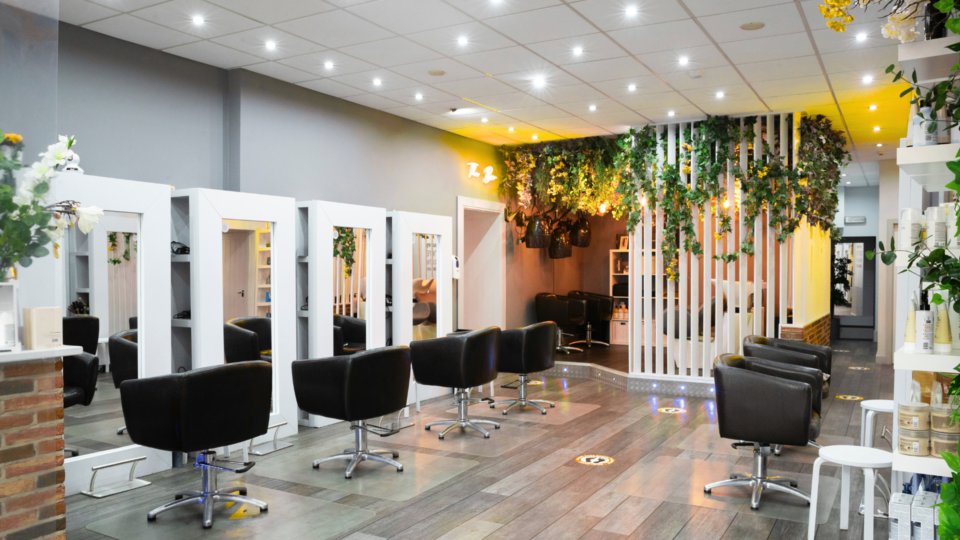 A hair salon with a lot of chairs and mirrors.