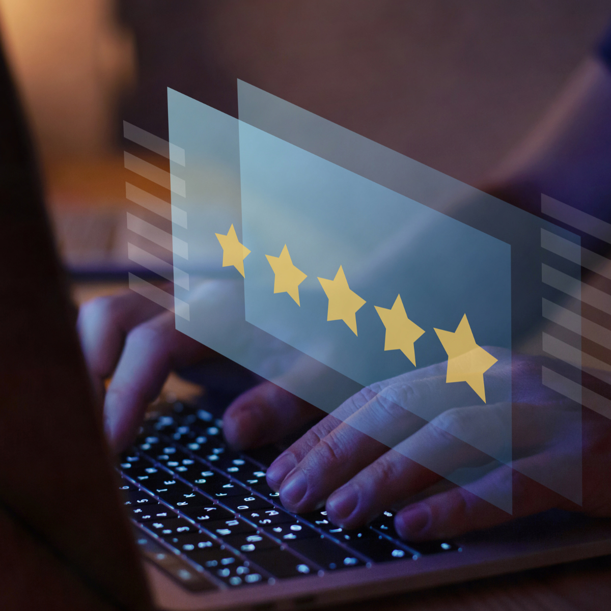 A person is typing on a laptop with a screen showing five stars