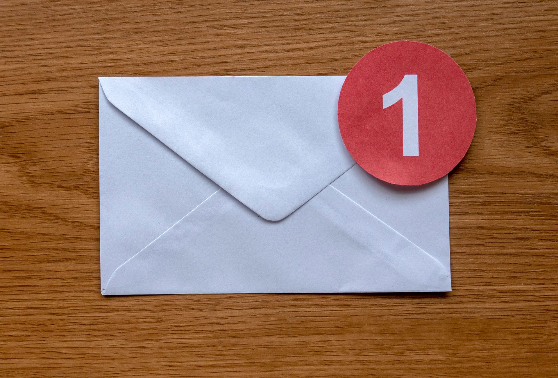 An envelope with a red circle with the number 1 on it