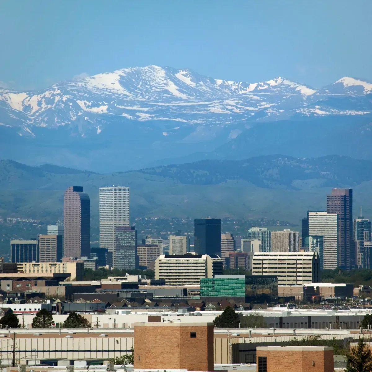 A city skyline with mountains in the background