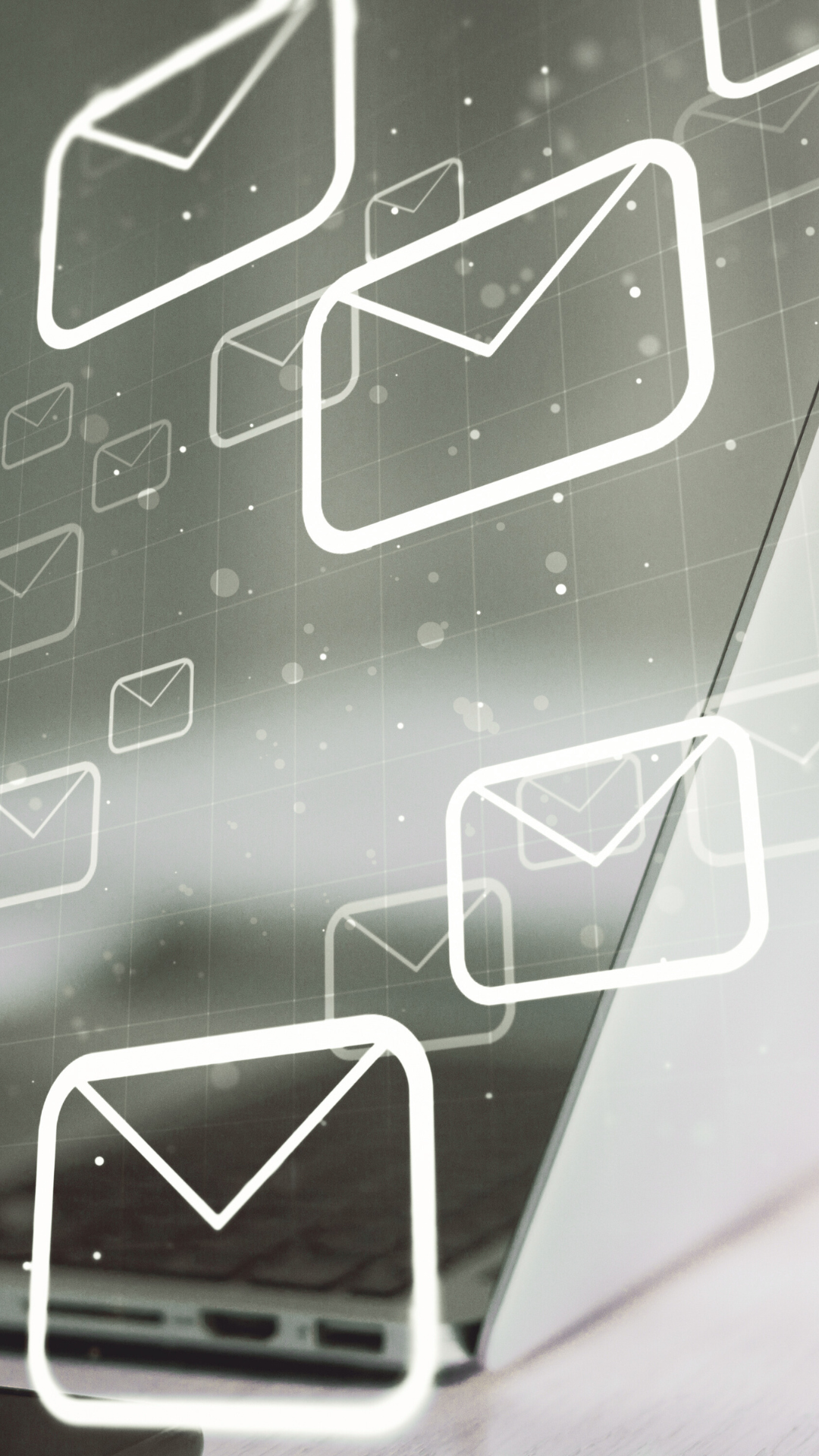 A bunch of envelopes are flying out of a laptop screen.