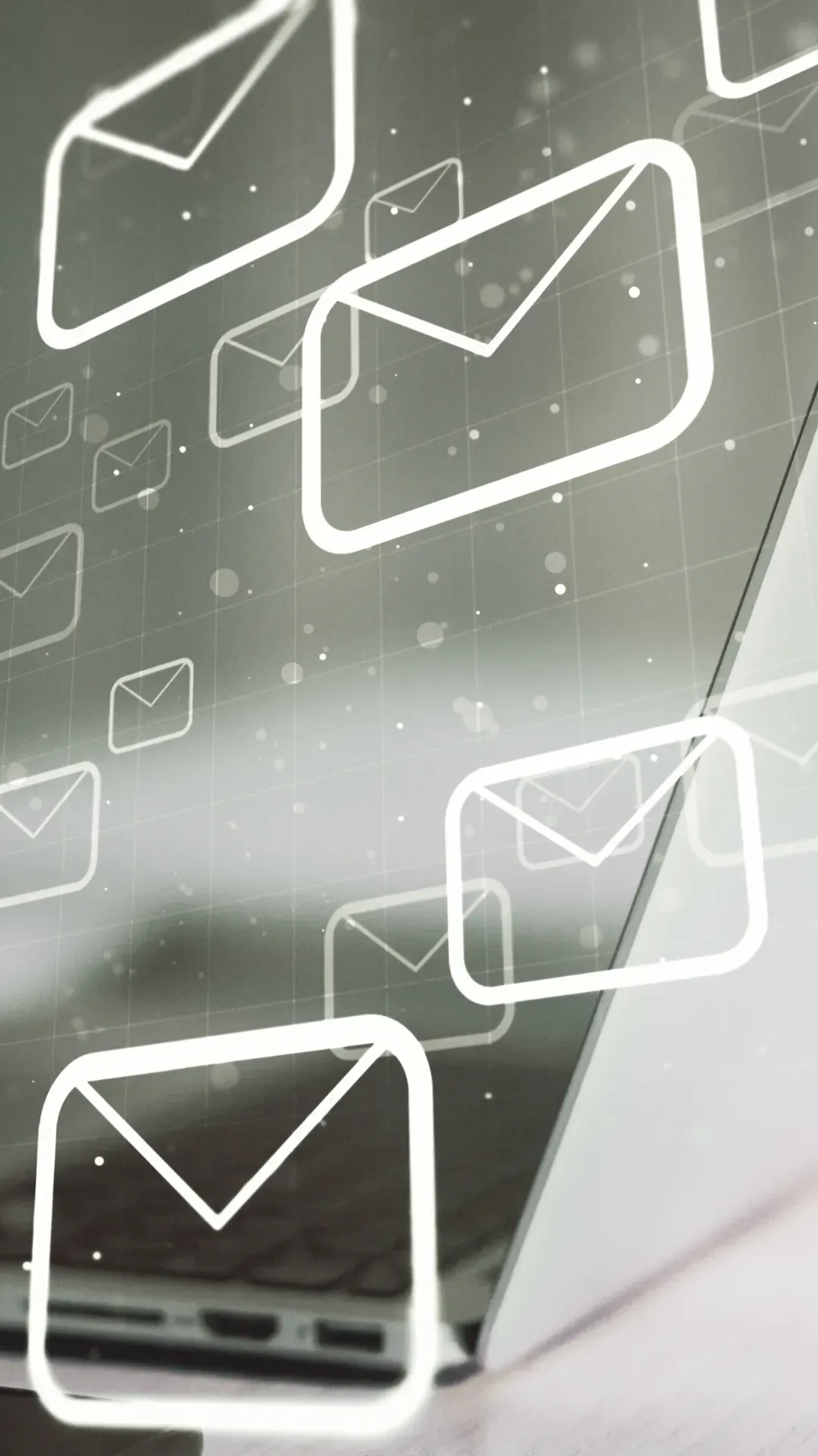 A bunch of envelopes are flying out of a laptop screen.