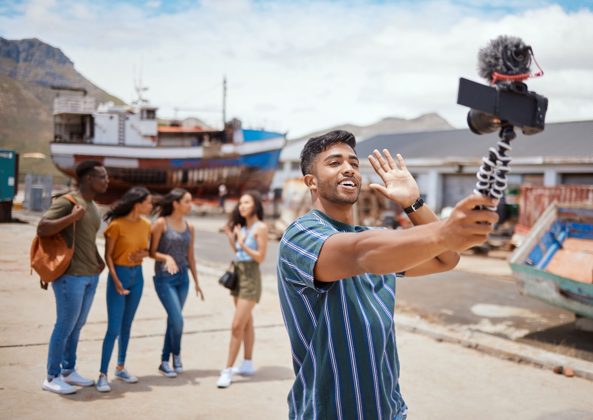 A man is taking a selfie with a camera on a tripod.