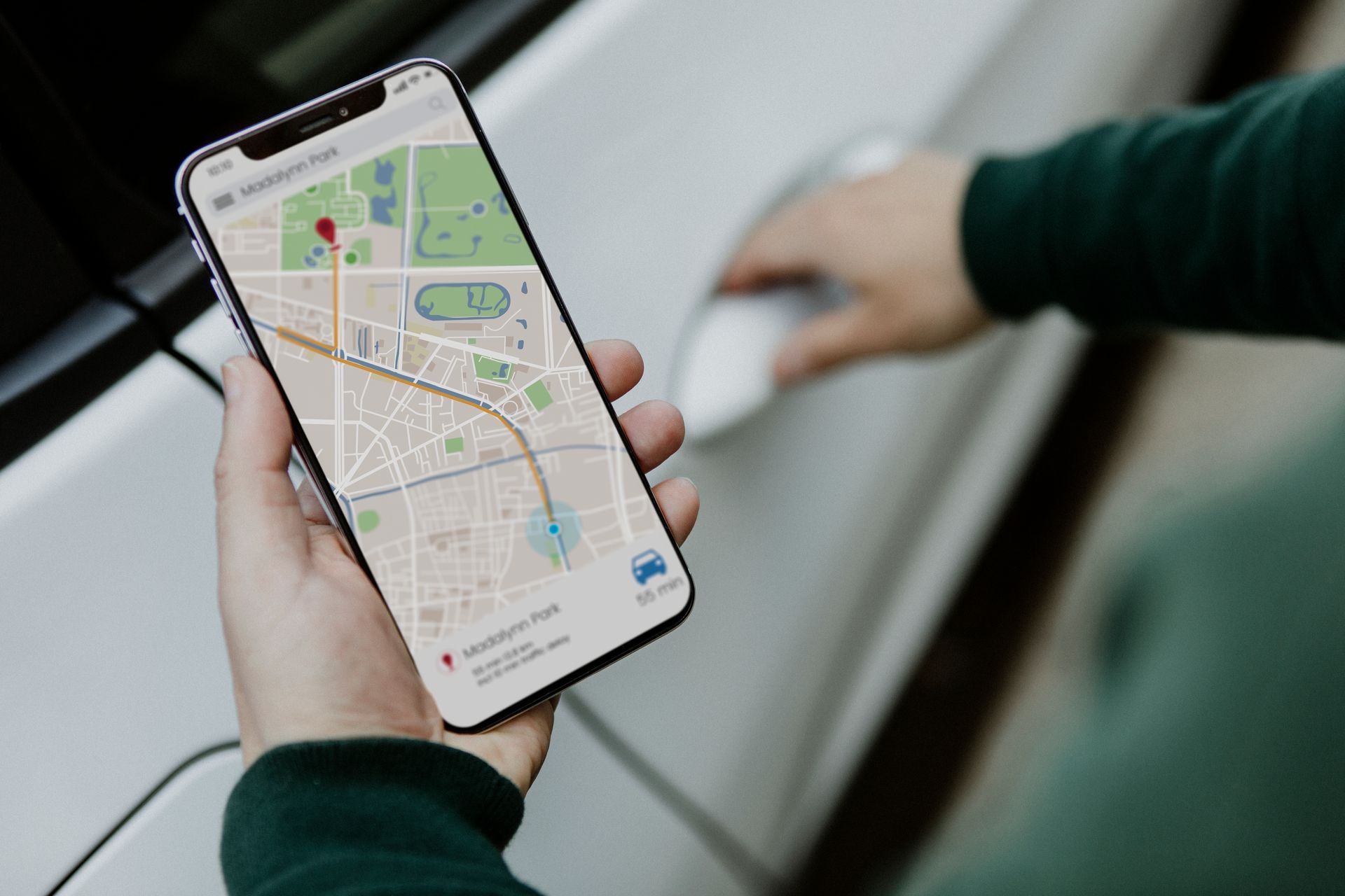 A person is holding a cell phone with a map on it.