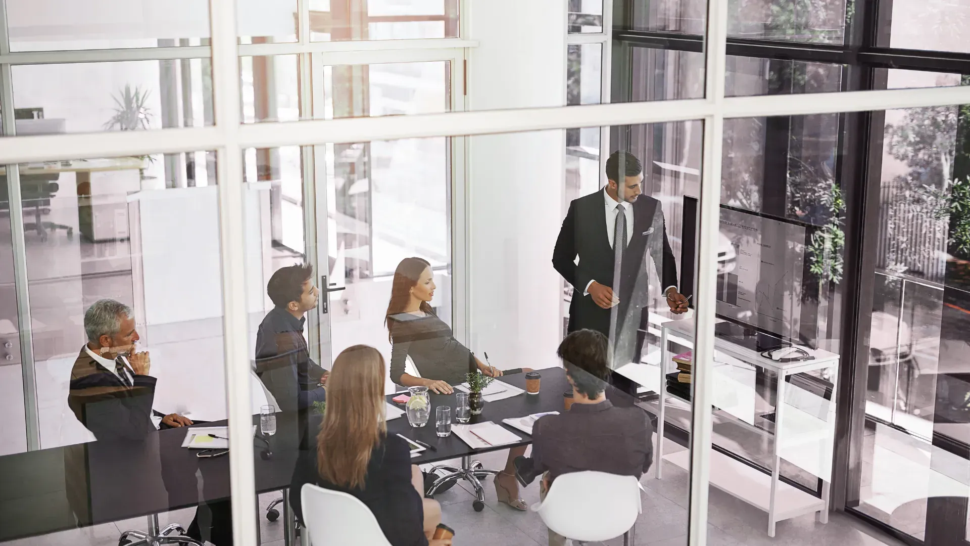 A group of business people are having a meeting in a conference room.