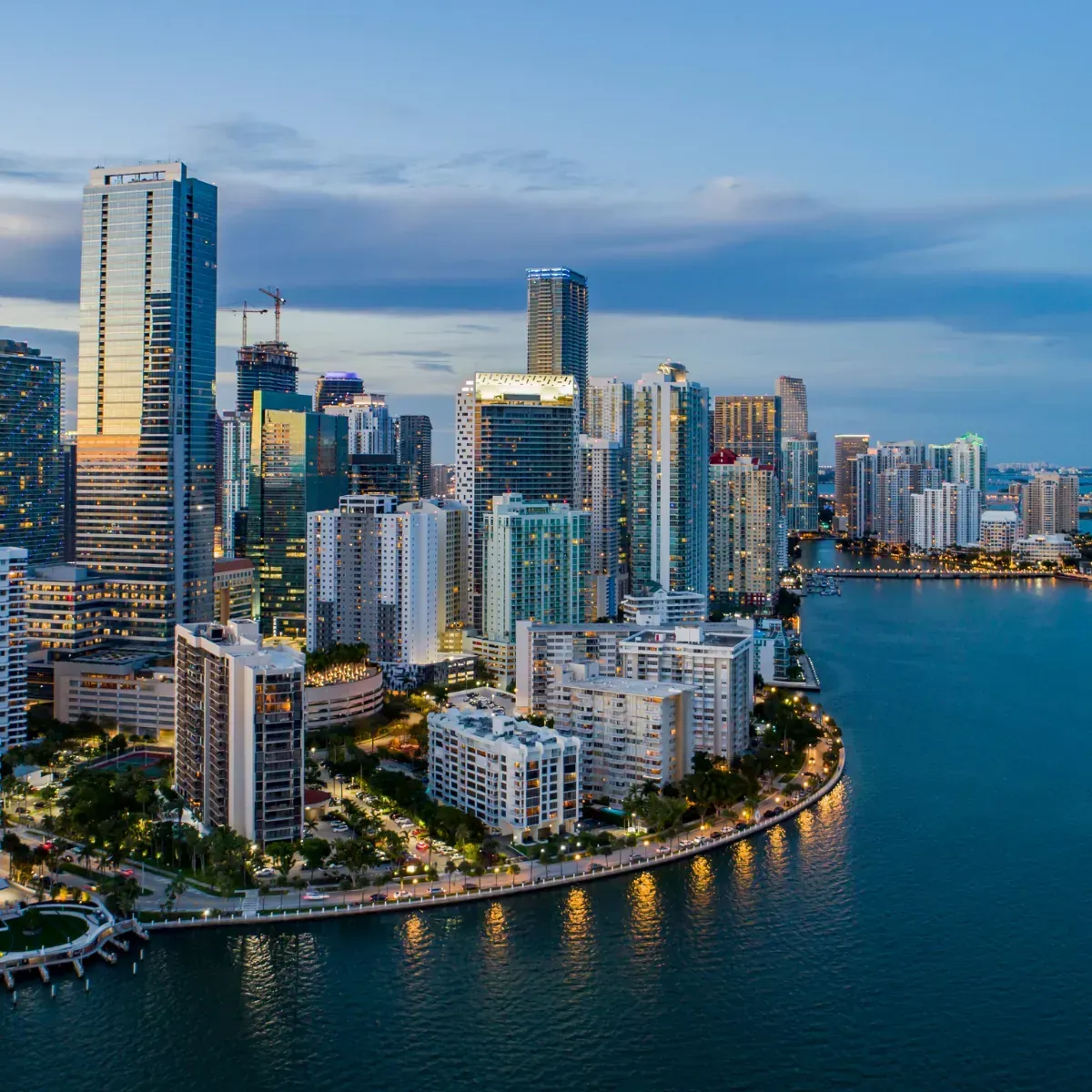 An aerial view of a city skyline with a large body of water in the foreground.