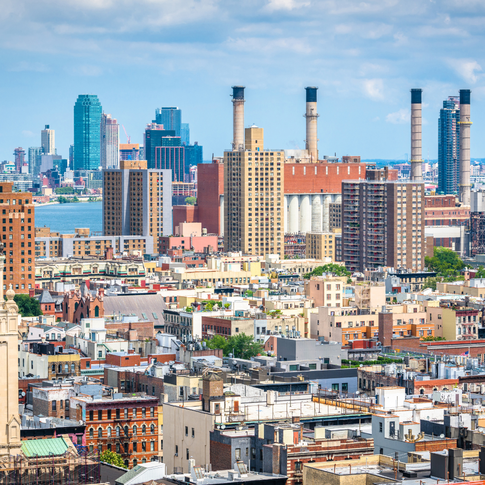 An aerial view of a city with lots of buildings and chimneys