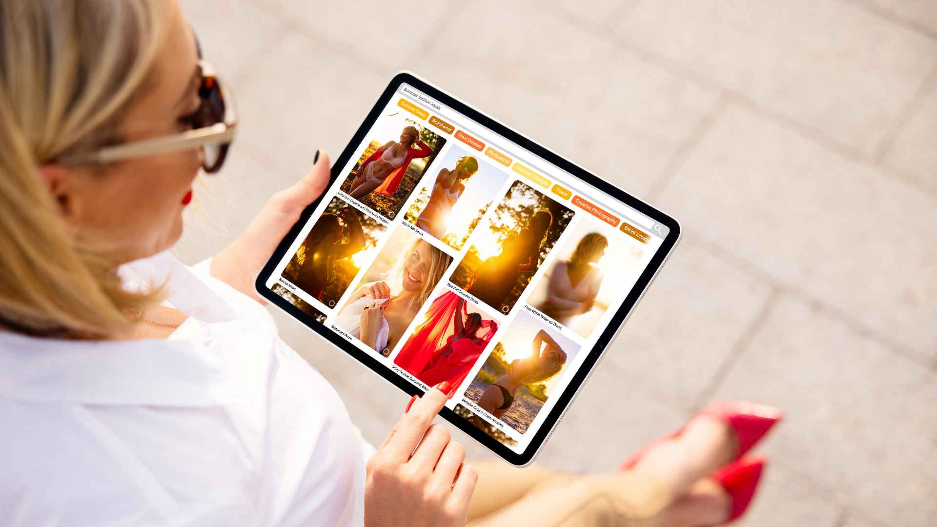 A woman is holding a tablet with a collage of pictures on it.