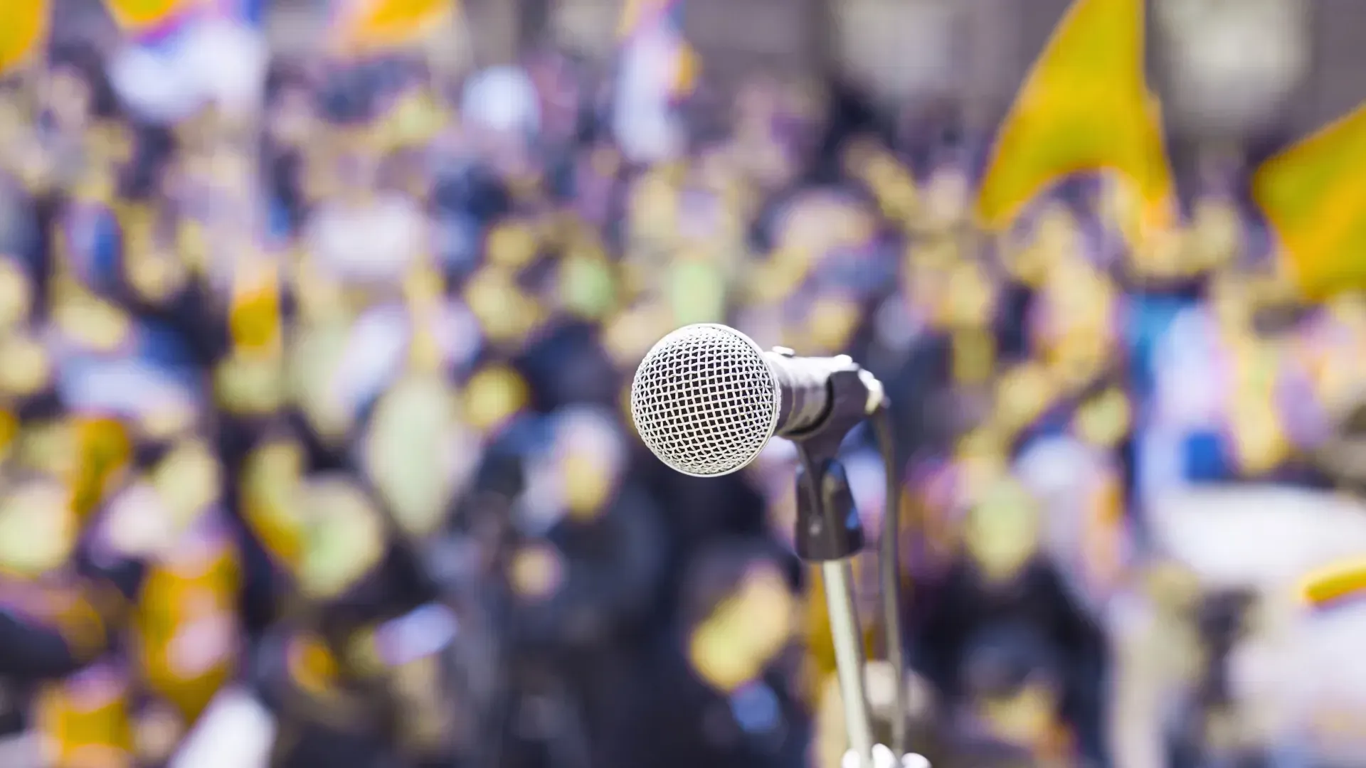 A microphone is sitting in front of a crowd of people.