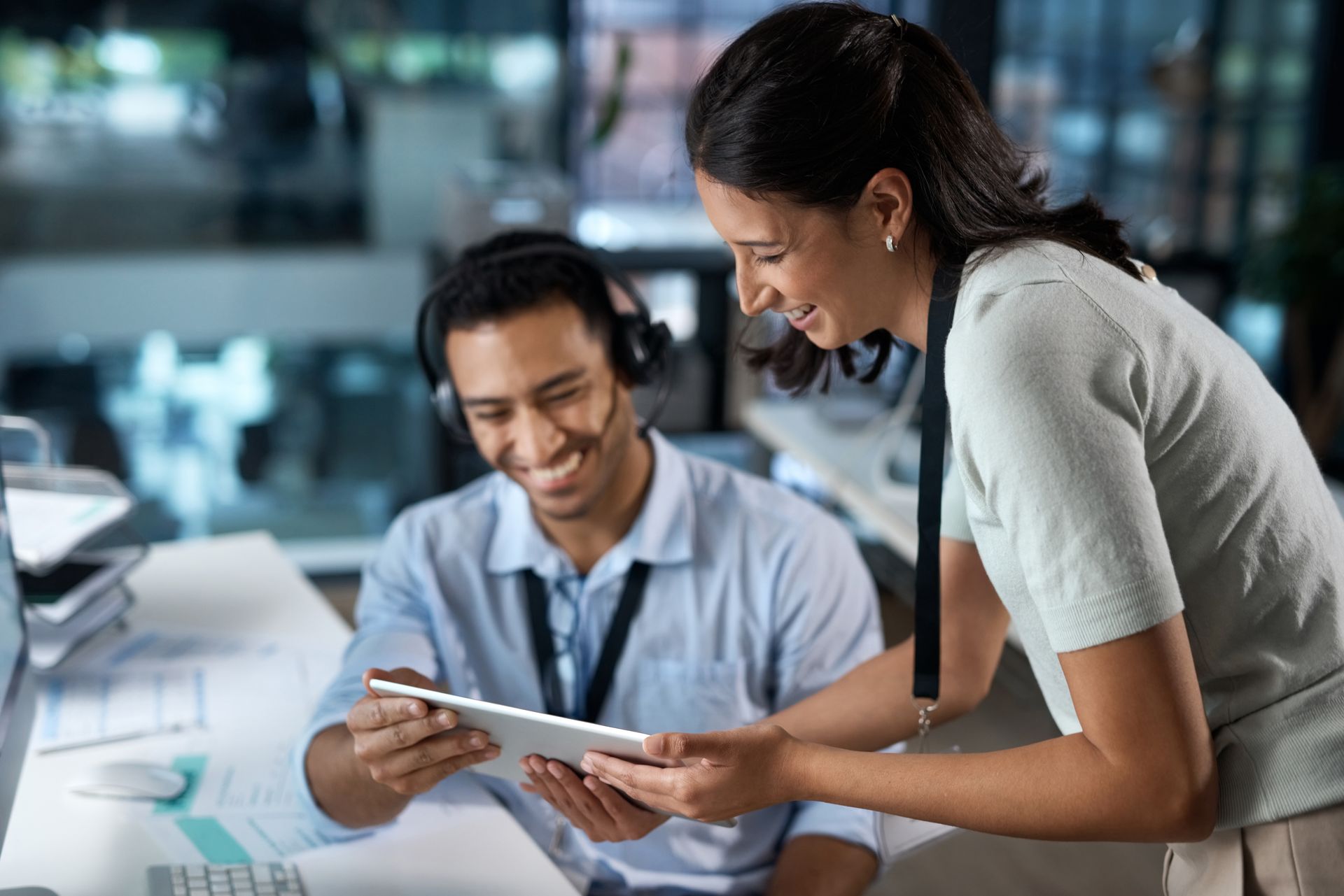 A man and a woman are looking at a tablet together.