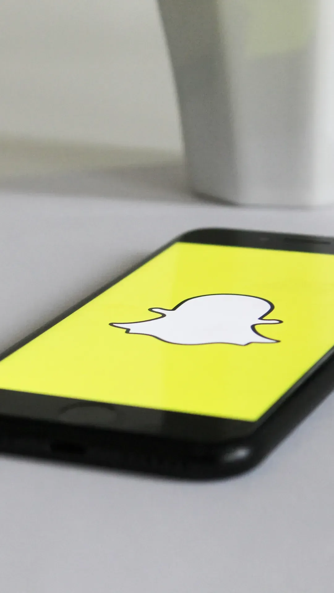A phone with a snapchat logo on the screen