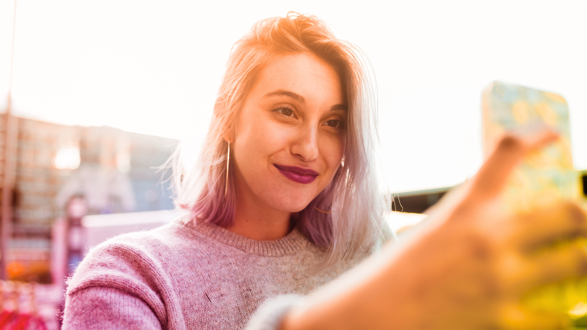 A woman is taking a selfie with her cell phone.
