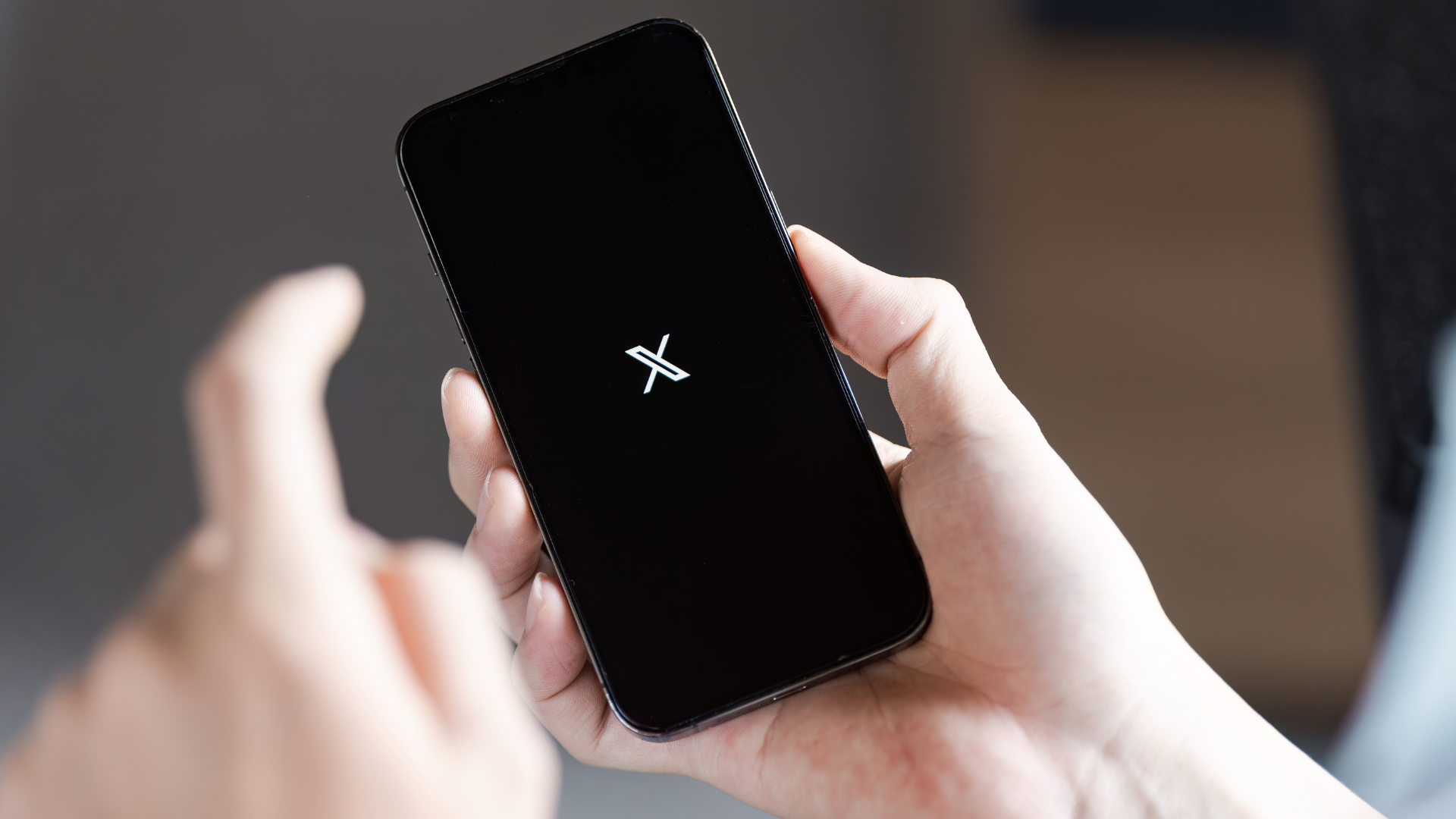 A person is holding a cell phone with a star on the screen
