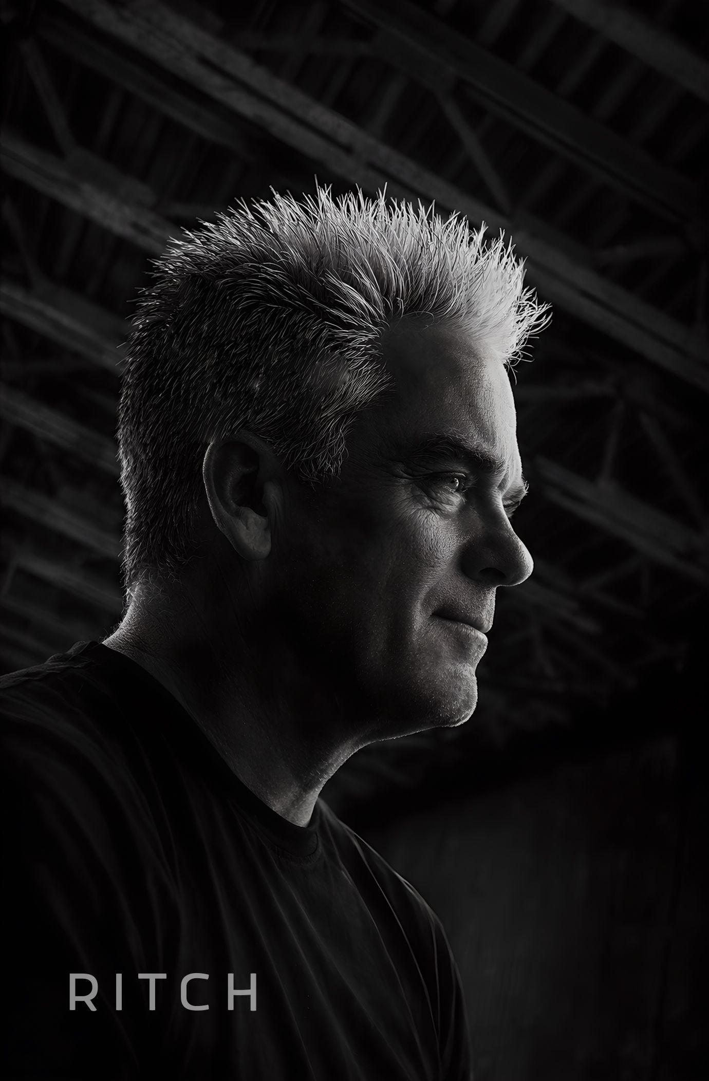 Black-and-white profile portrait of a spiky-haired man in shadow, with RITCH text at the bottom. Black-and-white profile portrait of a spiky-haired man in shadow, with RITCH text at the bottom.