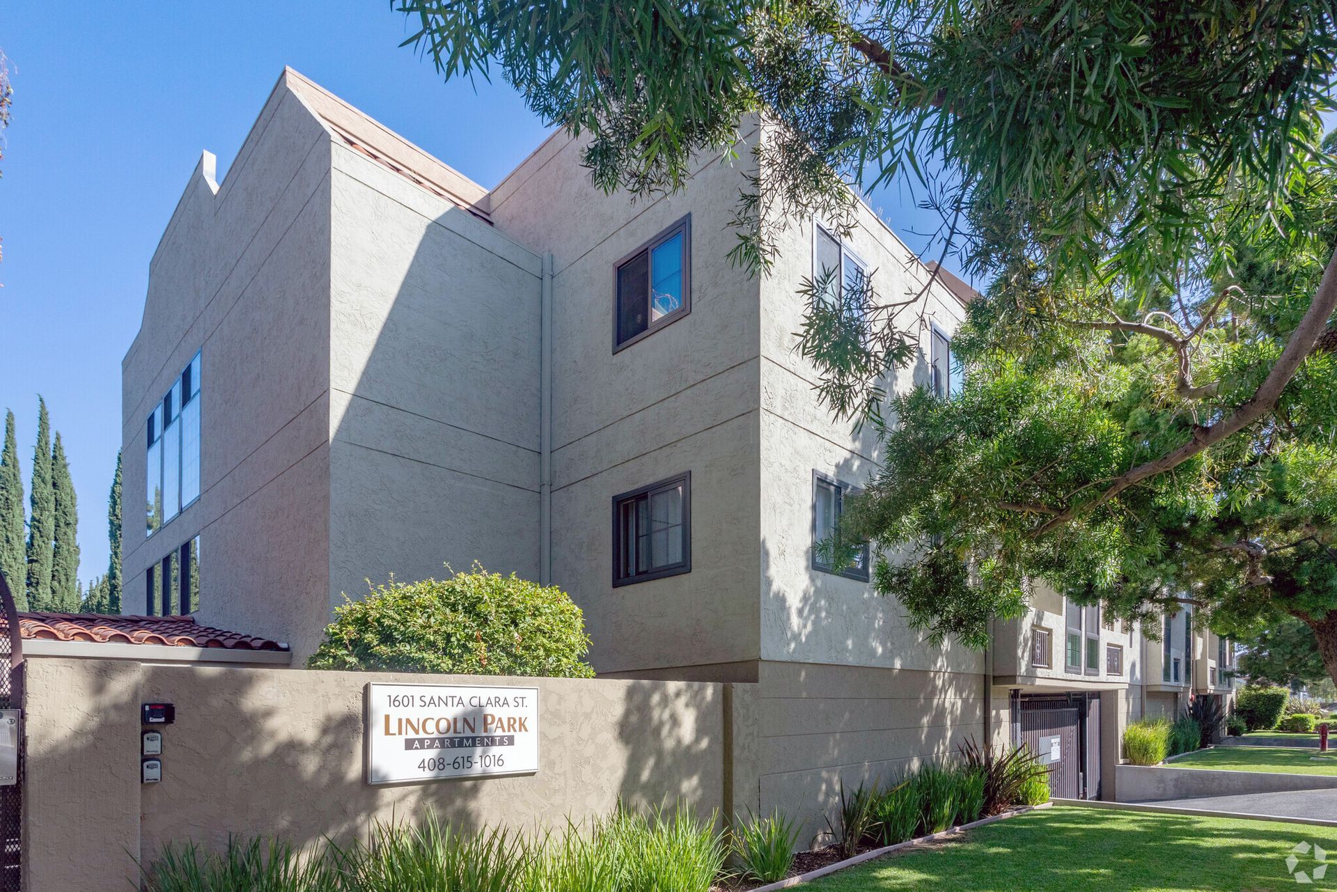 A large building with a sign on the side that says ' apartments '