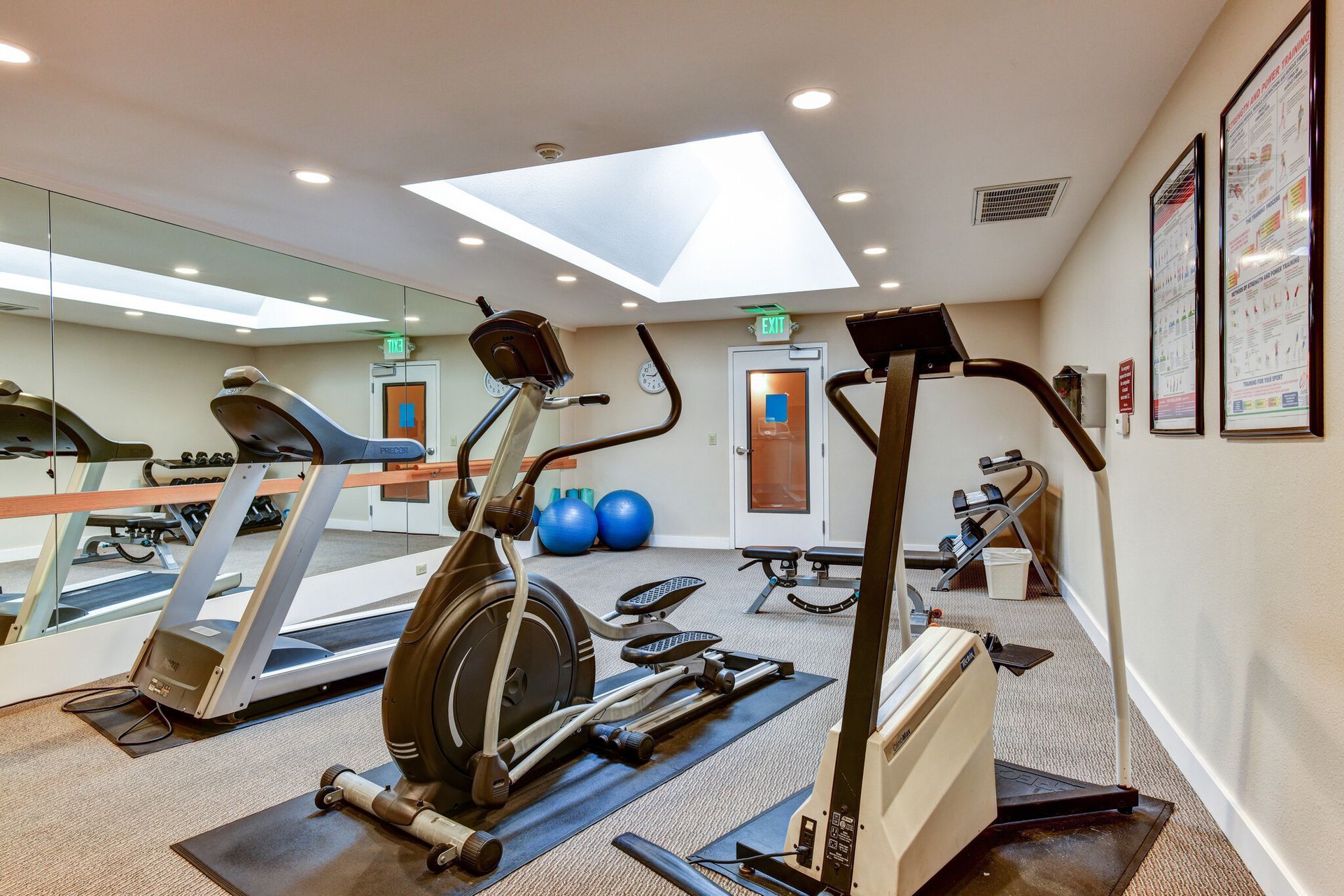 A gym with treadmills , ellipticals , and other exercise equipment