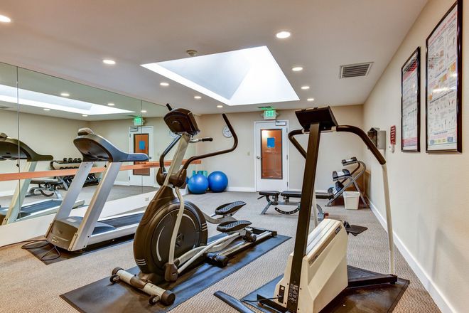 A gym with treadmills , ellipticals , and other exercise equipment