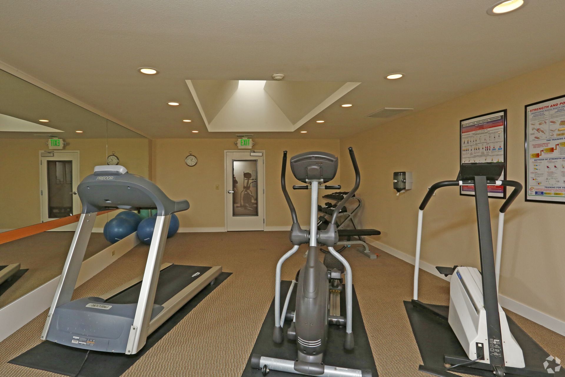 A gym with treadmills and exercise bikes