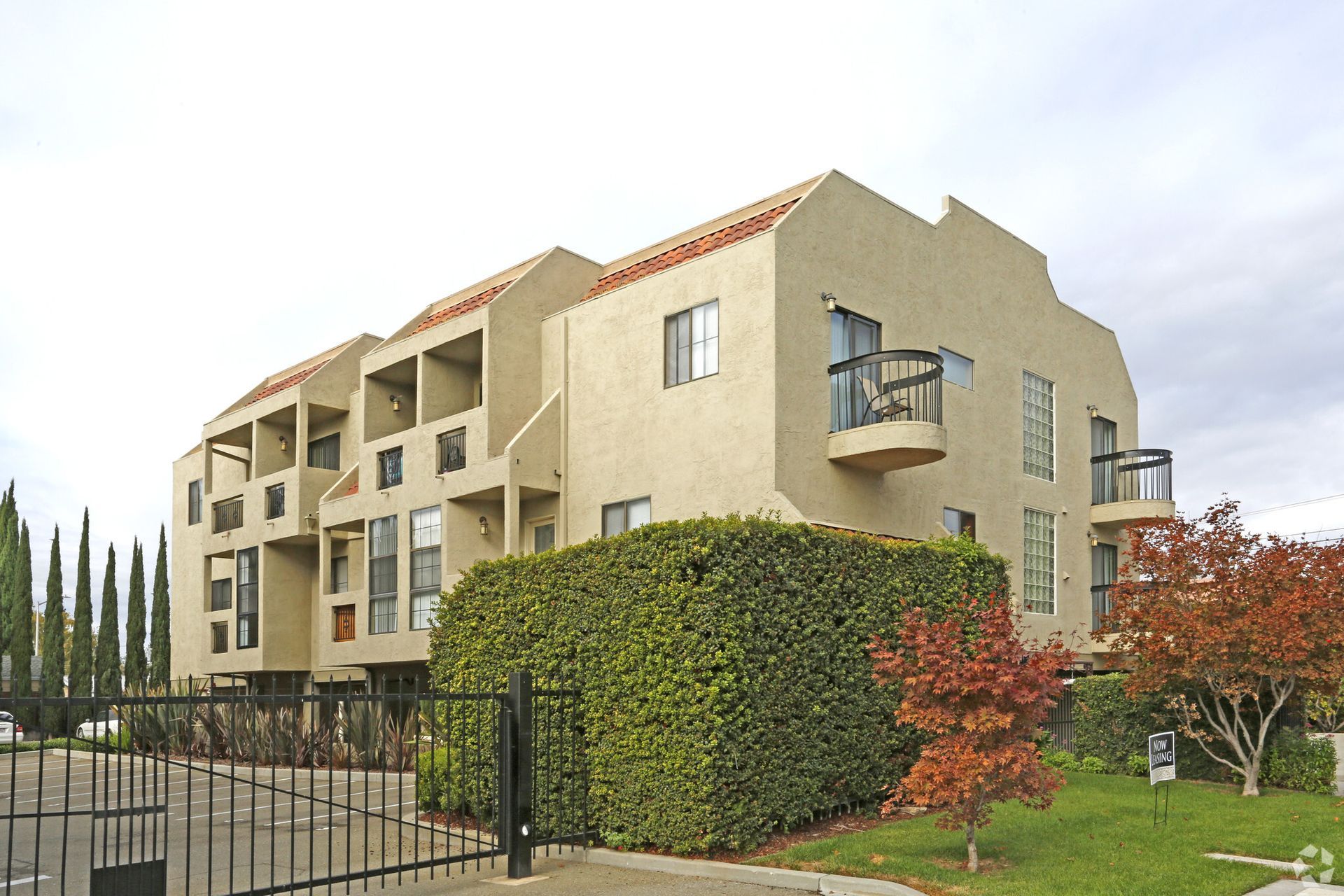 A large apartment building with a fence around it